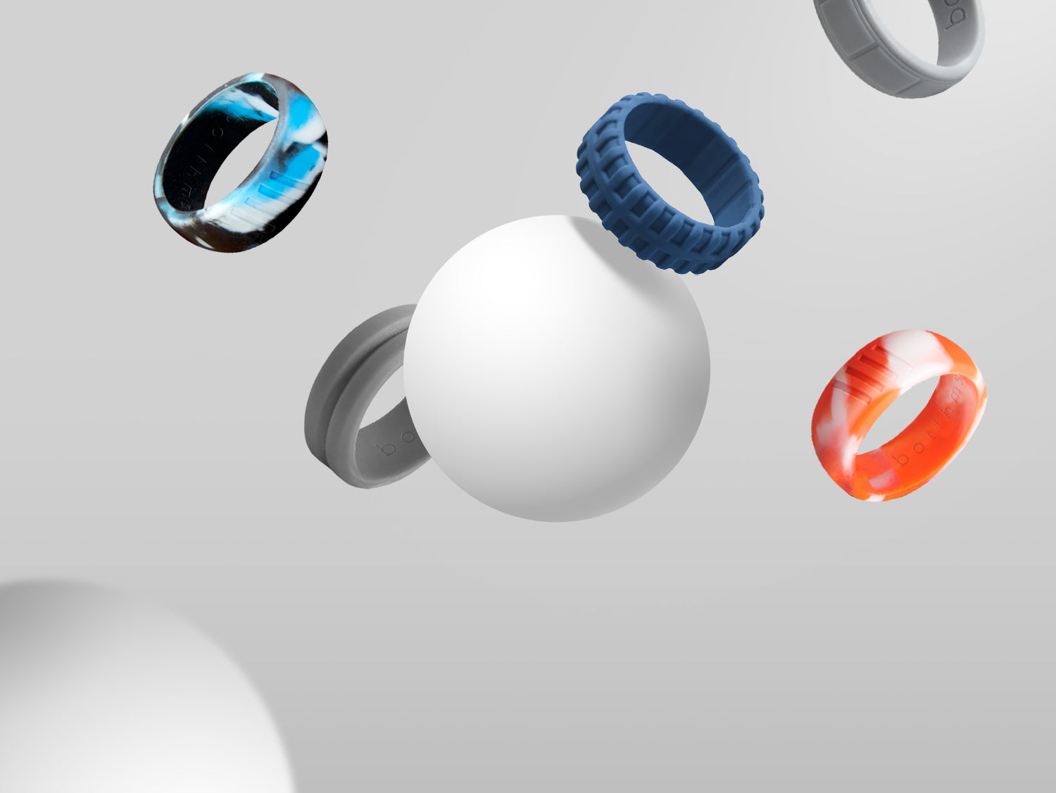 collection of botthms mens tree, groove and strype silicone rings of different color